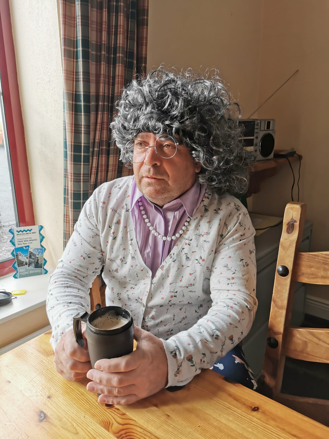 Scumrun Fundraiser has a well earned coffee while wearing a silly wig